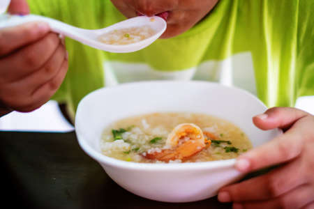 eatting boiled rice and shrimpの写真素材