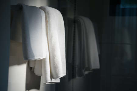 Bathroom Towel - white towel on a hanger prepared to useの写真素材