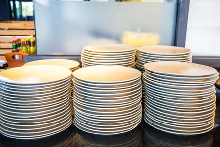 Set of white dishes on tableの写真素材