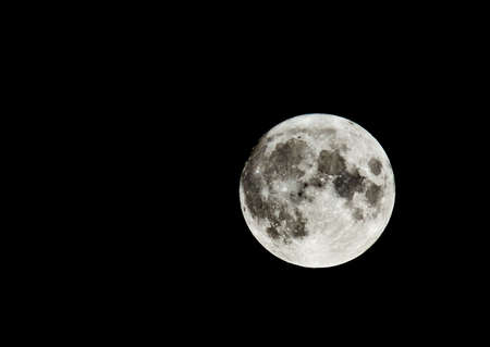 Full moon in the sky. Craters are visible.