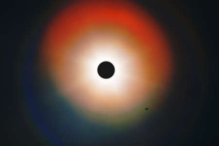Solar eclipse and airplane on a background of the skyの写真素材