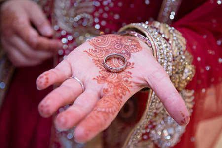 Indian bride with ring in hand showing hennaの写真素材