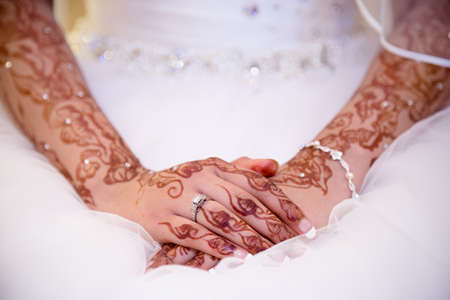 brides hands in henna with ringの写真素材