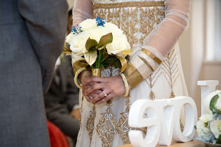 bride holding bouquet during ceremonyの写真素材
