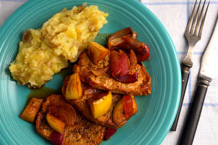 Porkchop with onion, apples and mashの写真素材