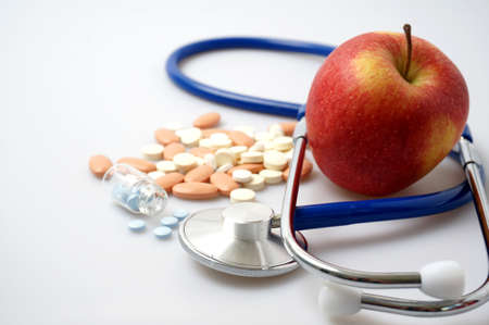Medicine and apple, health vs sicknessの写真素材