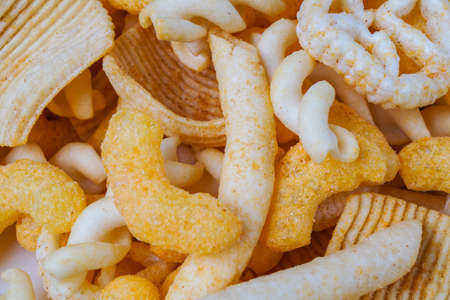 pile with a various of salty snacksの写真素材