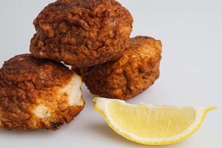 fresh fried fish cakes served with lemonの写真素材