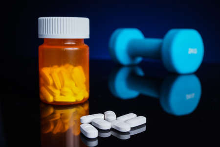 Dumbell and medicial tablets. Doping, muscle growthの写真素材