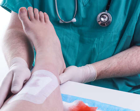 Doctor patches a Wound on the Legの写真素材