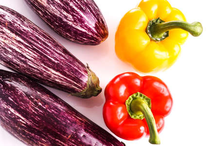 Raw ripe Striped healthy eggplants and bell peppers, isolated on whiteの写真素材