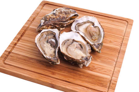 Gourmet fresh french oysters on a wooden boardの写真素材