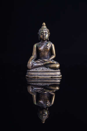 Statue of the Buddah isolated on blackの写真素材