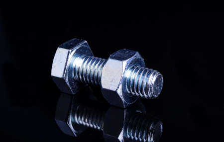 Bolt and Nut, isolated on black backgroundの写真素材