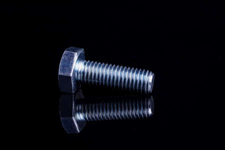 Shiny metal Bolt or screw isolated on black background