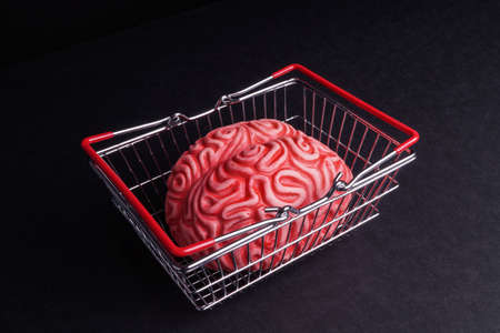 Think before you Bye. Brain and shopping isolated on Blackの写真素材