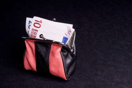 Money in the Purse, with copy space and isolated on Blackの写真素材