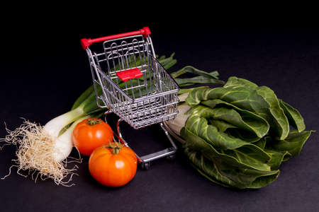 Chopping Cart with vegetable isolated on Blackの写真素材