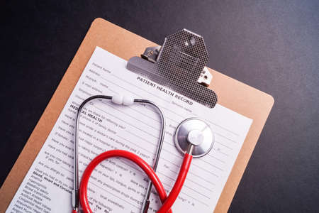 Medical Chart and stethoscope isolated on black backgroundの写真素材