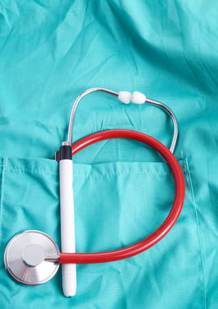 Surgeon with stethoscope in pocket, isolated on green background with stethoscope in pocket