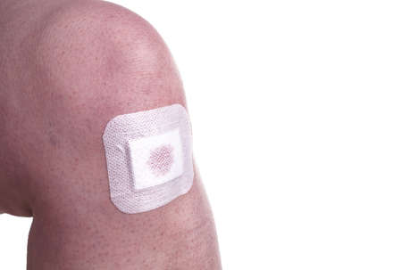 Women with wounds on her knees. The damage is treated with an adhesive bandage , so to prevent the...