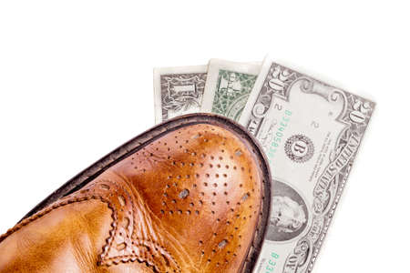 Dollars under a pair of Shoes. Business and Money or the cost of a Date. Isolated on Whiteの写真素材