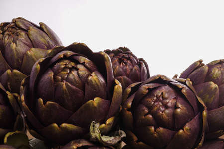 Pile of Purple artichokes ready for cookingの写真素材