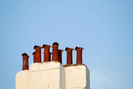 the City chimneys against the blue clear skyの写真素材
