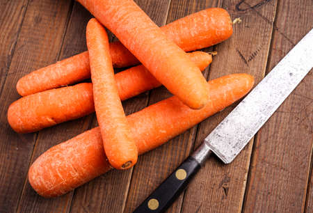 Fresh organic Carrots, lying on wooden boardの写真素材