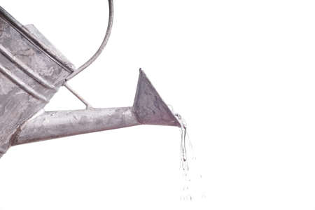 water dripping out of the metal watering canの写真素材