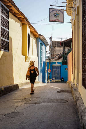 Santiago de Cuba, Cuba - January 10, 2016: Typical scene of one of streets in the center of Santiago de cuba - Colorful architecture, people walking around. Santiago is the 2nd largest city in Cubaのeditorial素材