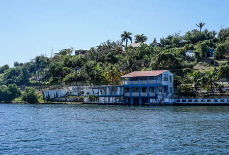 lake views with boathouse in tropical landscape with green hillsの写真素材