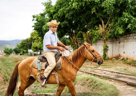 Trinidad, Cuba - January 14, 2016: Trinidad's residents still use horses for transportation. Cuba has one of lowest vehicle per capita rates in the world. In Cuba sits the local cowboys, Gaucho, in the saddle all day. They are a regular part of the local のeditorial素材