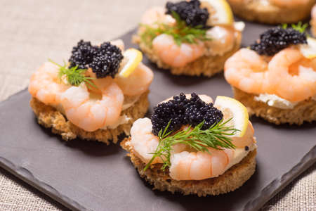 Shrimp Appetizer served on toasted bread and served on a slate plateの写真素材