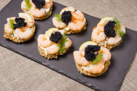 Shrimp Appetizer served on toasted bread and served on a slate plateの写真素材