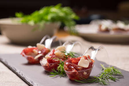 Appetizer with meat, Carpaccio and parmesan served on a Spoonの写真素材