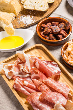 Tapas food, served in small bowls cold meat, goat cheese. A meal for sharingの写真素材