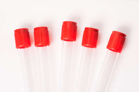 five test tubes for blood samples with red cap, isolatedの写真素材
