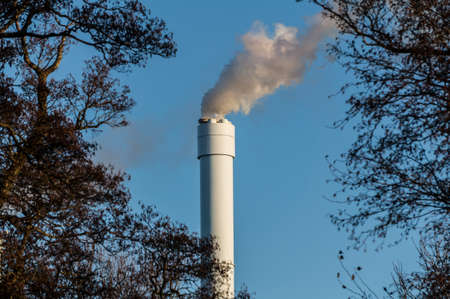 There will be polluted smoke against a clear blue sky from the tall chimney