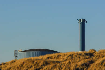 Agricultural silo which can be glimpsed over the hillの写真素材