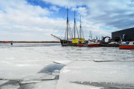 Harbor and ships in the winter with frozen waterの写真素材