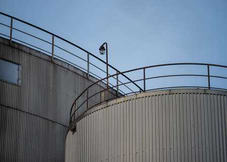 Industrial silos, tall and against the grey skyの写真素材