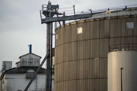 Industrial silos. Tall and with grey crane