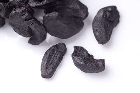 Pile of Black Garlic isolated on white backgroundの写真素材