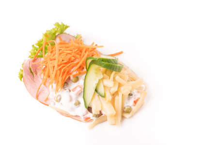 Danish specialties and national dishes, high-quality open sandwich. Sandwich with sliced ham, Mayonnaise with green peas and carrot tart, cracked carrots, asparagus and cucumbersの写真素材