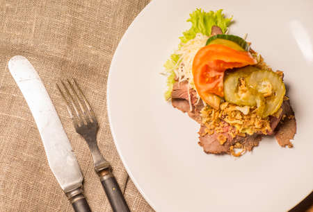 Danish specialties and national dishes, high-quality open sandwich,Roast beef with remoulade and roasted crisp onions, served on a plate ready for eatingの写真素材