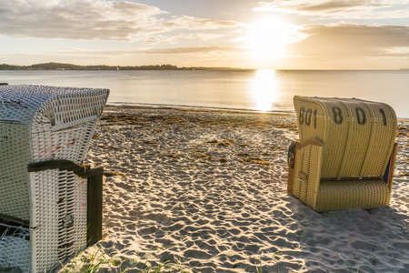 European Beach wicker chairs are placed decoratively on the beach for summer guests in the sunの写真素材