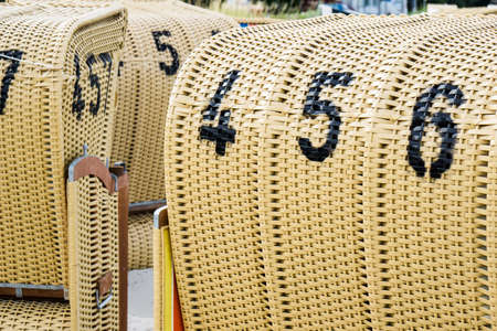 European Beach wicker chairs are placed decoratively on the beach for summer guests in the sunの写真素材