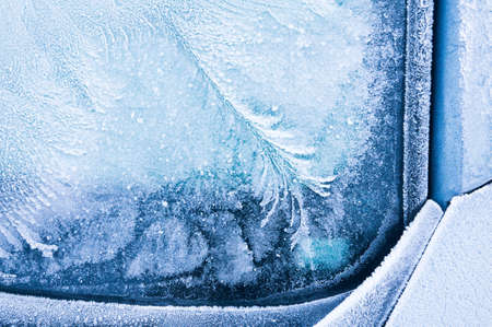 Iceflowers, frozen.The ice-cold frost forms ice crystals in beautiful unique patterns on the window, Hood and wiper on the Carの写真素材