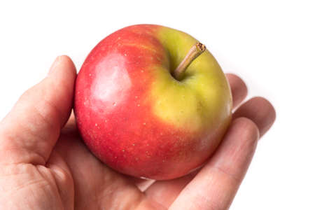 causasian hand holding apple isolated on white backgroundの写真素材